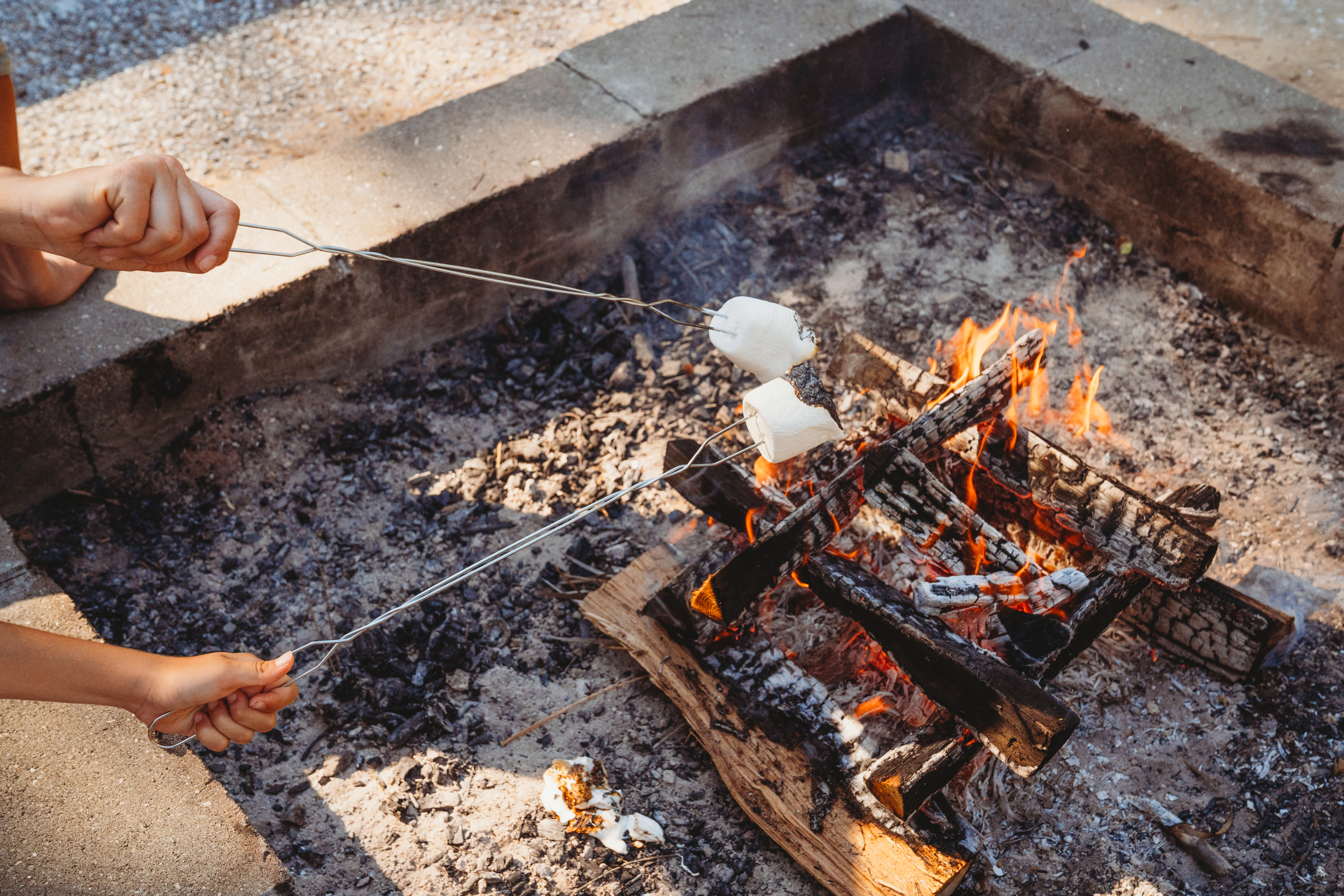 A closeup of roasting marshmallows over an open fire. 