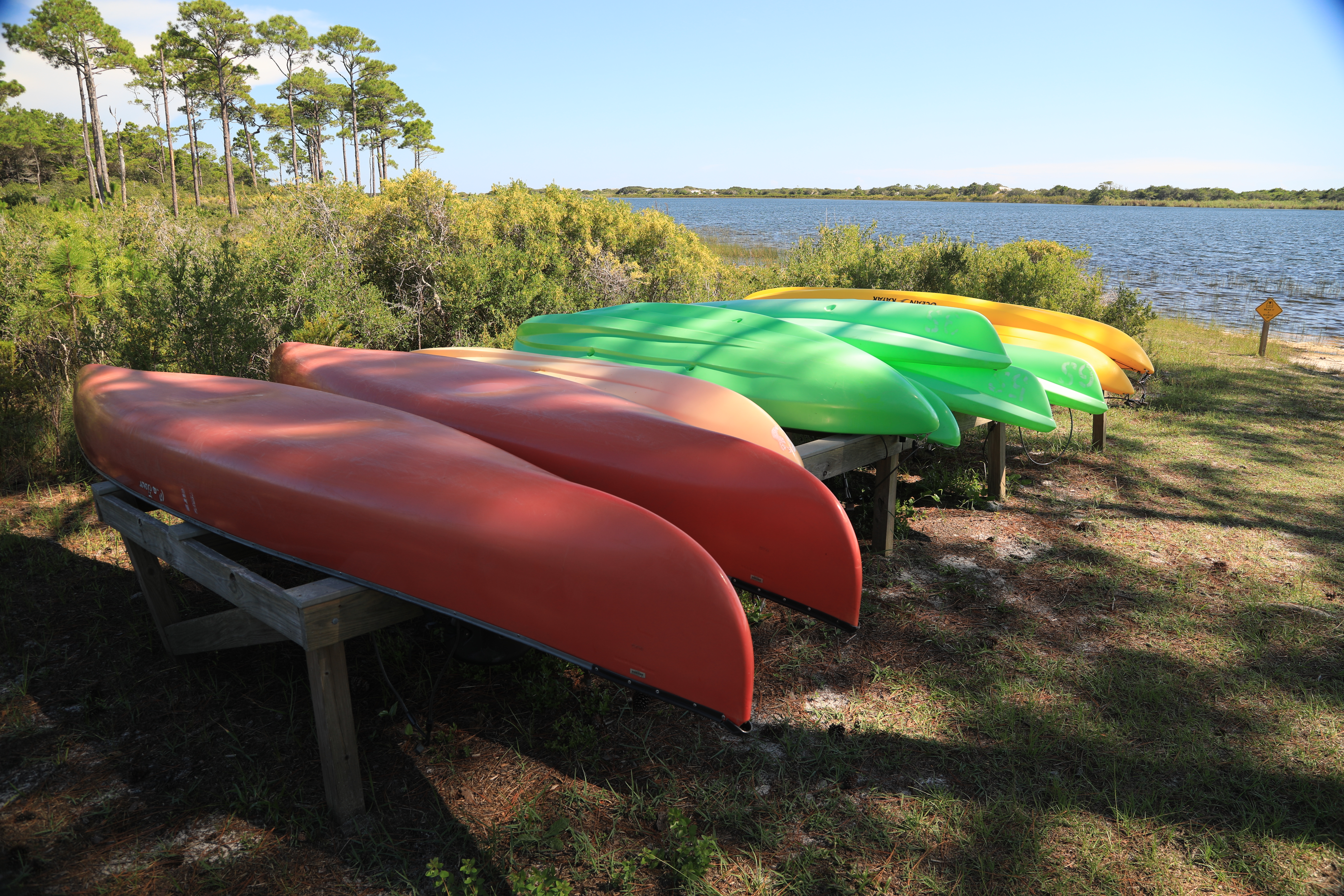 A row of canoes and kayaks in Topsail Hill Preserve State Park. 