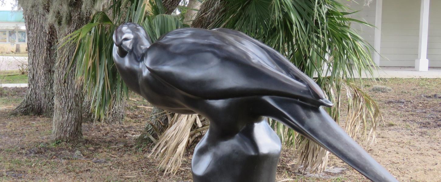 A view of Caroline the Carolina Parakeet statue at the park.