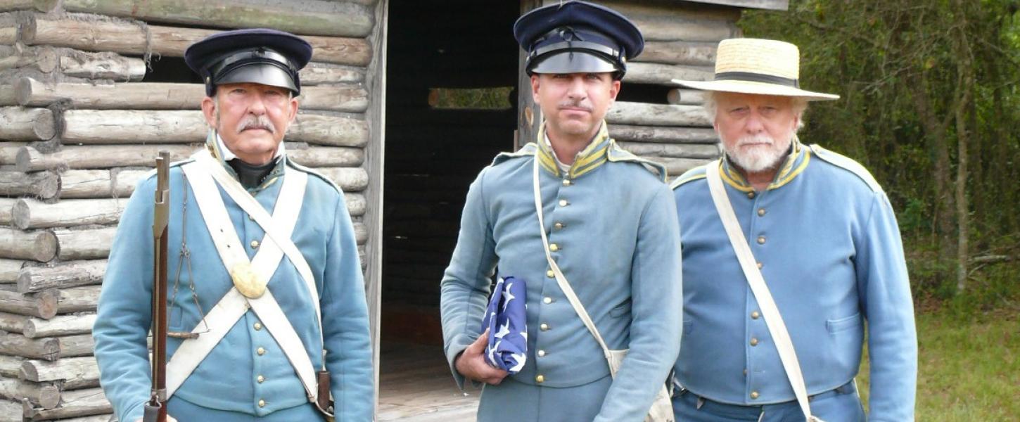 A group of reenactors dressed in uniform.
