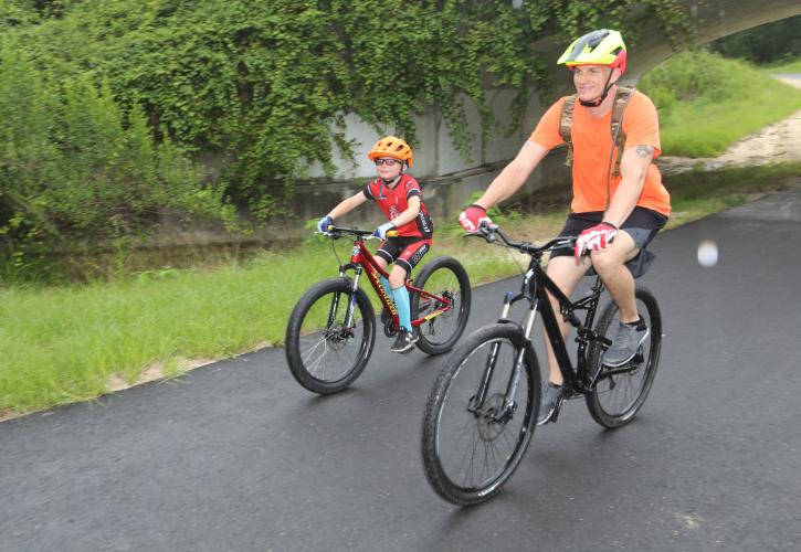 Two people ride bikes on the Marjorie Harris Carr Cross Florida Greenway.