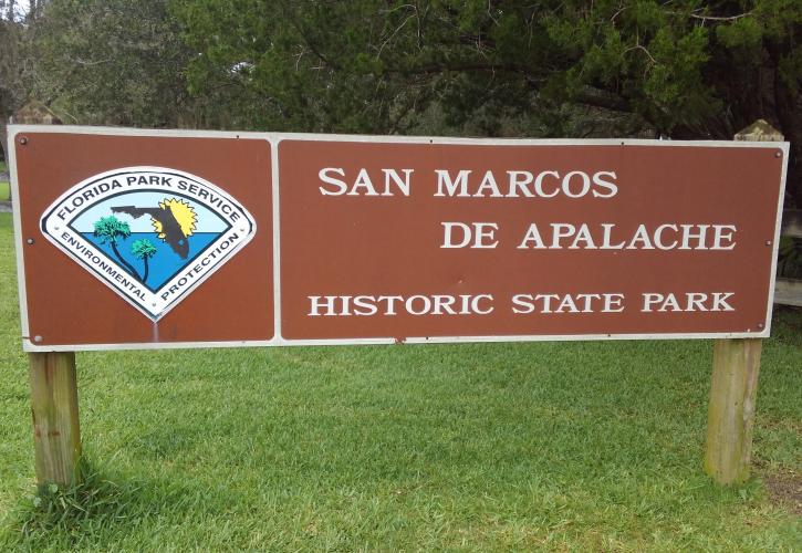 A metal sign at the entrance of the San Marcos de Apalche State Park 