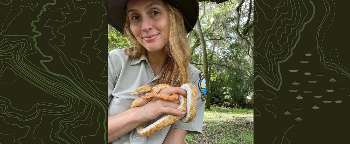 Ranger Jasmin holds a yellow corn snake.