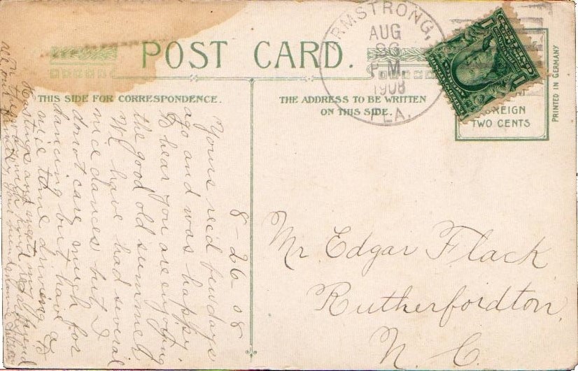 A tan colored postcarg with writing and a stamp in the corner. 