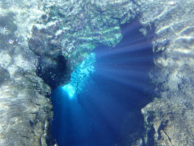 Light is seen beaming down through the Blue Hole Spring opening.