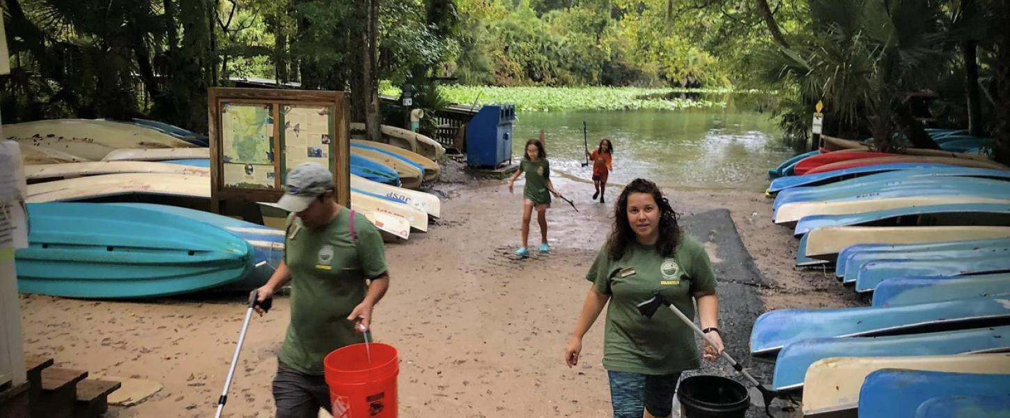 Members of the Nieves family pick up litter.
