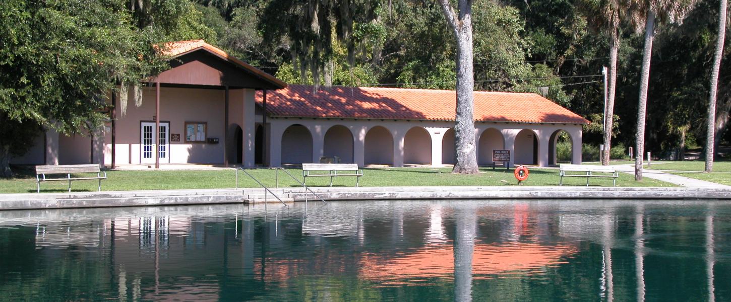 A view of the welcome center at de leon springs in front of the water.