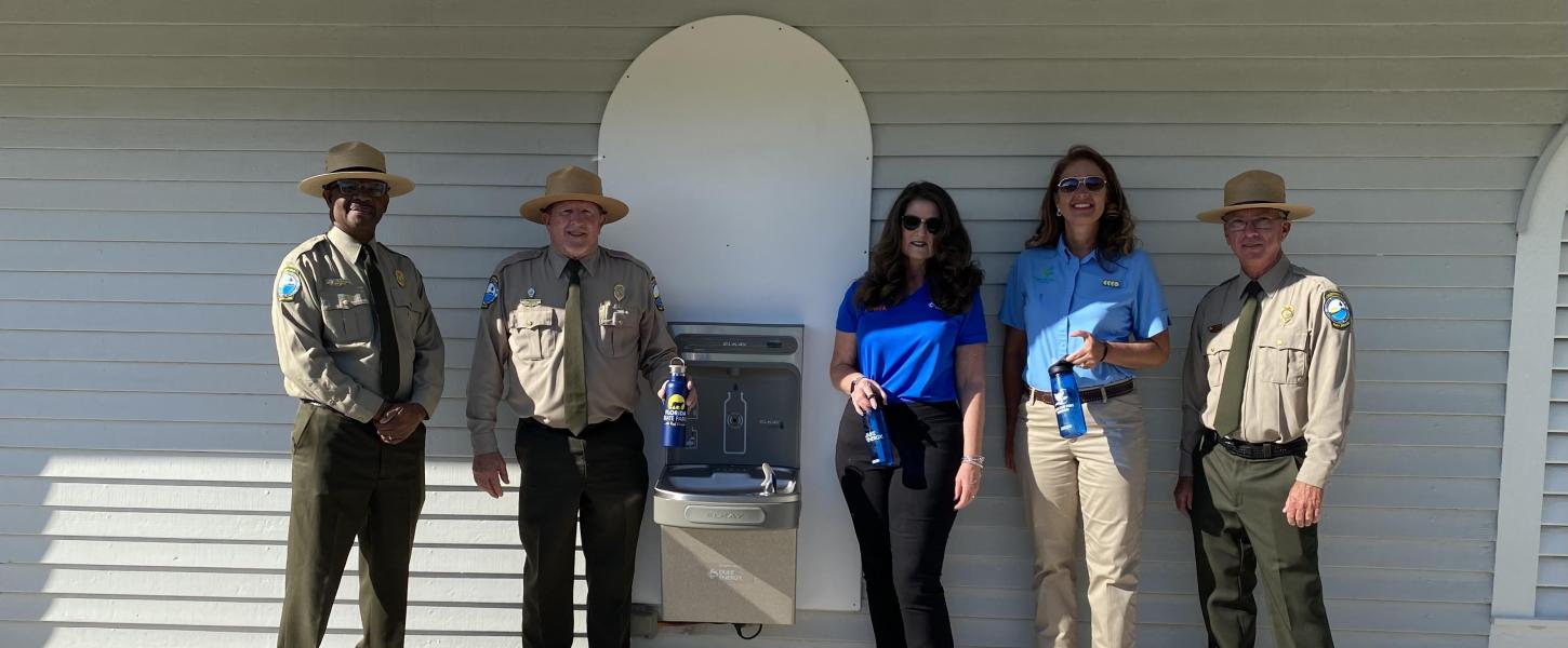 Officials pose for a photo with a refilling station at Honeymoon Island State Park. Left to right: BJ Givens, Bureau Chief, Chuck Hatcher, Director, Sharon Arollyo, Duke Energy Florida, Tammy Gustafson, Florida State Parks Foundation and Donald Bergeron, manager at Honeymoon Island State Park.
