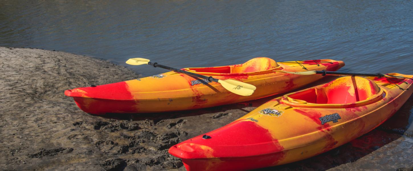 Two red and yellow kayaks rest in the sand at Little Talbot Island State Park.