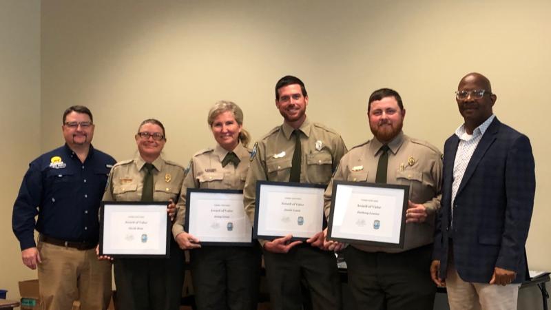 Brian Fugate and BJ Givens present the 2022 Award of Valor to the Koreshan State Park team.