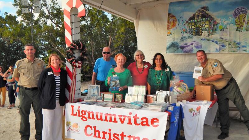 Friends of the Islamorada Area State Parks pose by a booth at the Holiday Festival