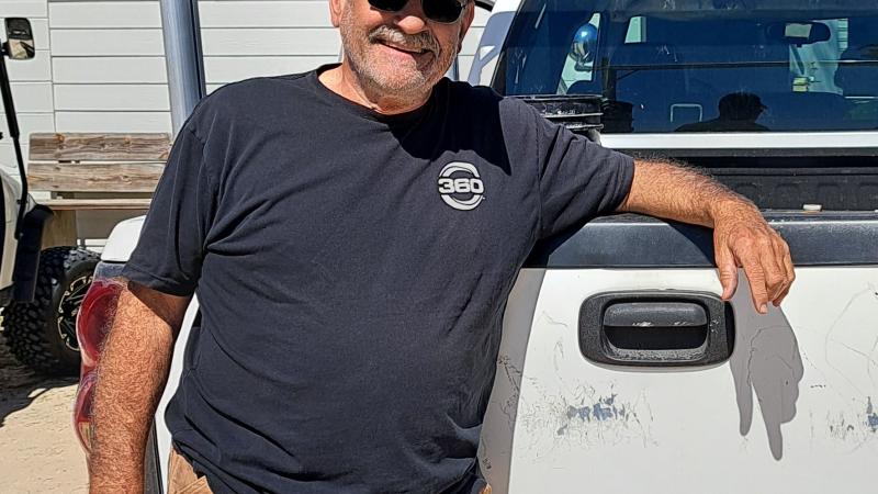 Gary standing beside a work truck