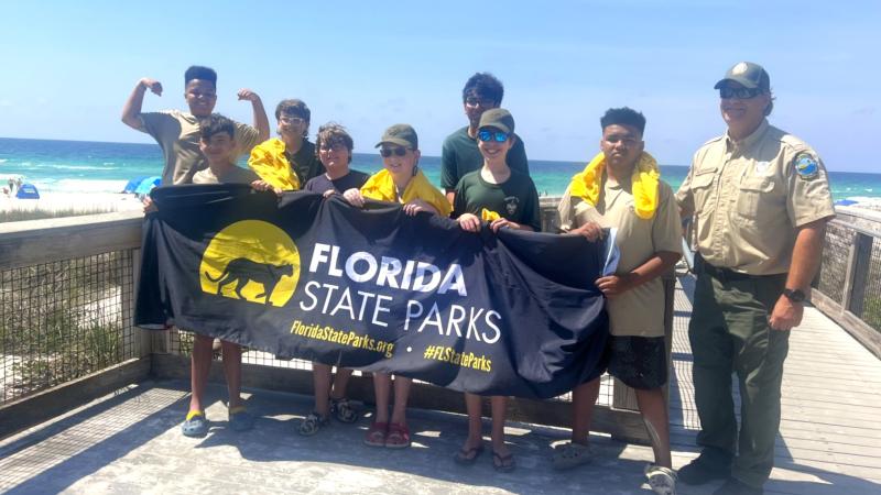 Boy Scouts and Park Specialist, Mike standing on a boardwalk