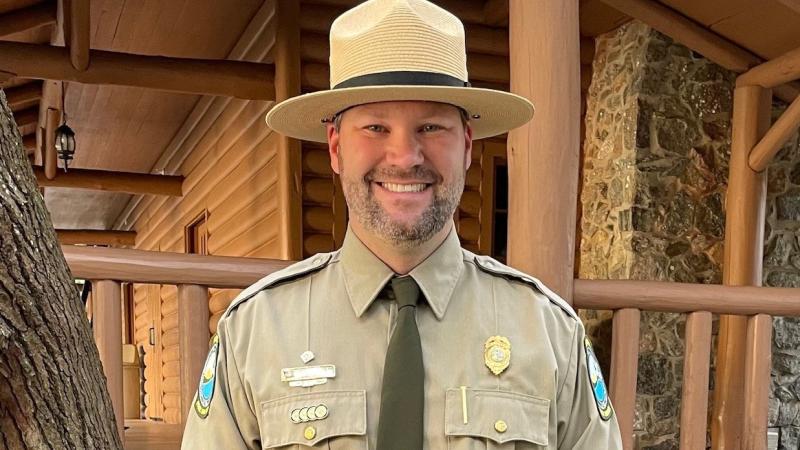 Wesley smiling in front of the Lodge