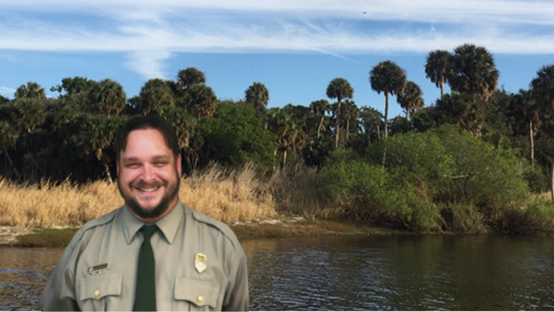 Park Manager posed in front of a river