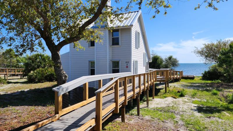 A boardwalk leads to one of eight cabins with a view of St. Joseph Bay.