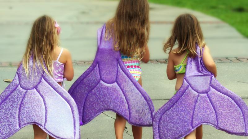 Little Girls Holding Mermaid Tails