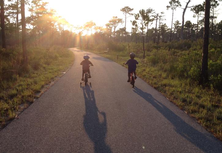 Children riding bicycles on paved trail