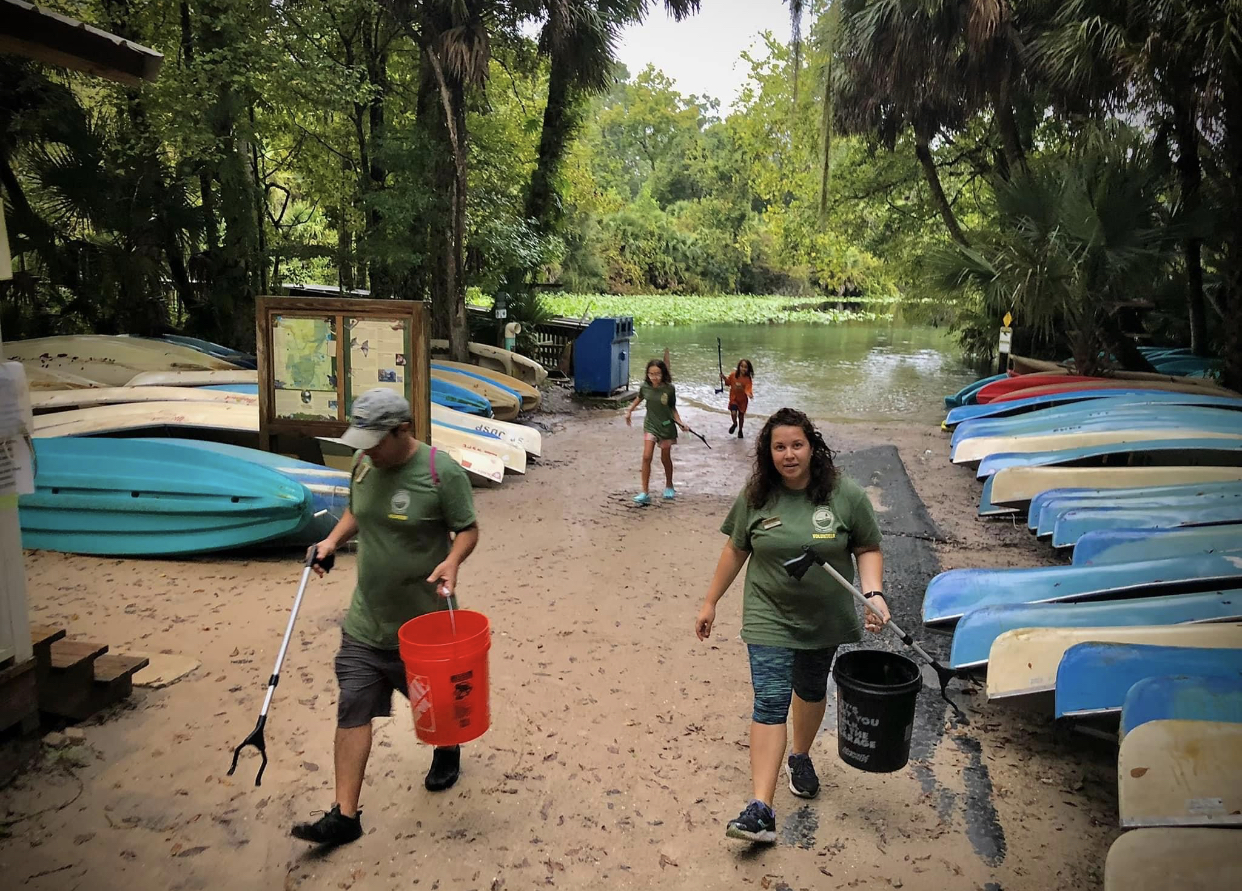 Members of the Nieves family pick up litter.