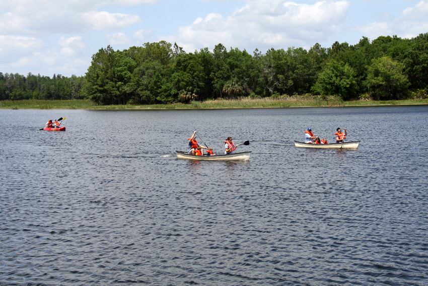 3 canoers paddling at Mac Lake