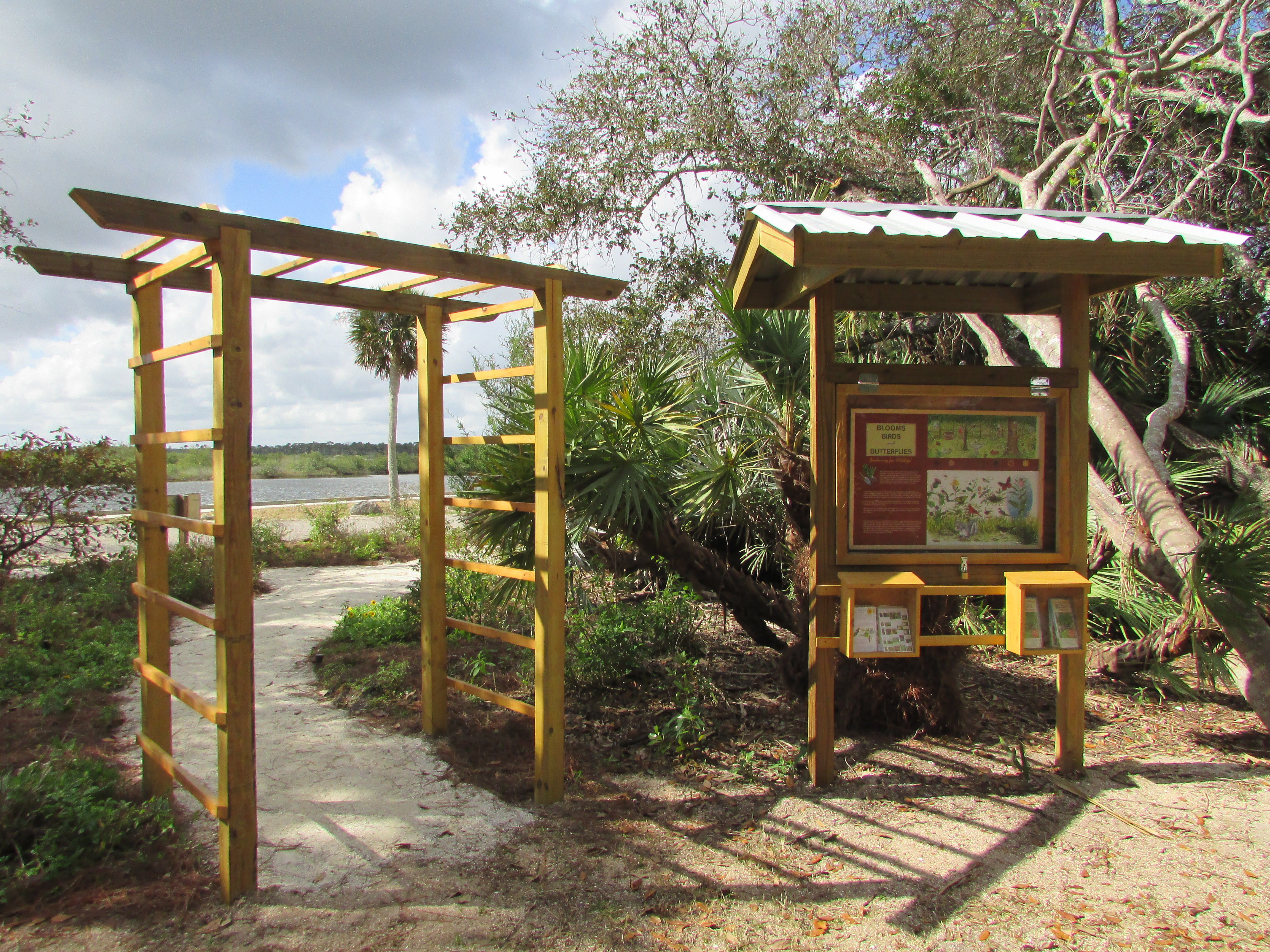 Wooden interpretive kiosk outside of butterfly garden