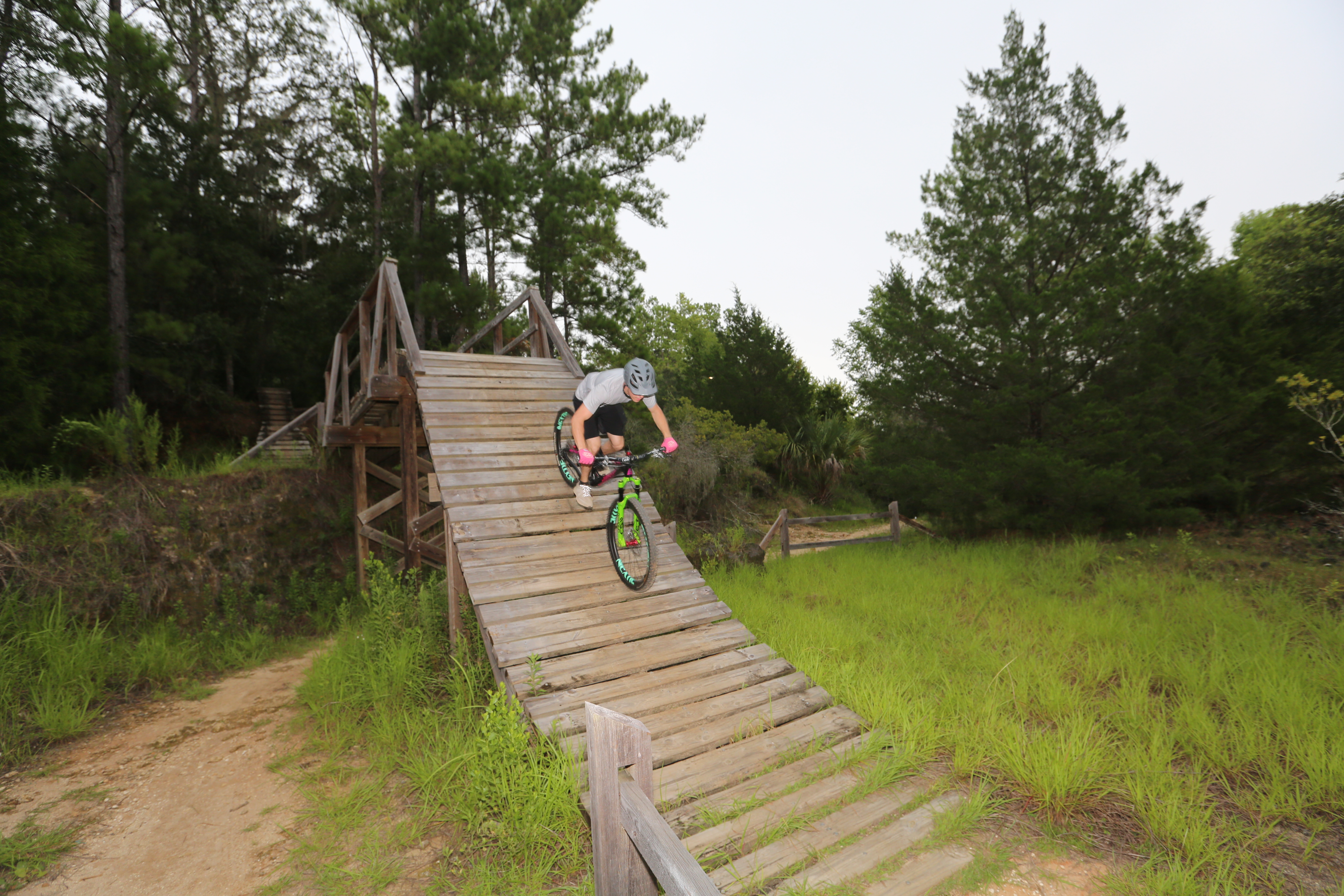 Mountain Biker riding down a steep wooden bike ramp