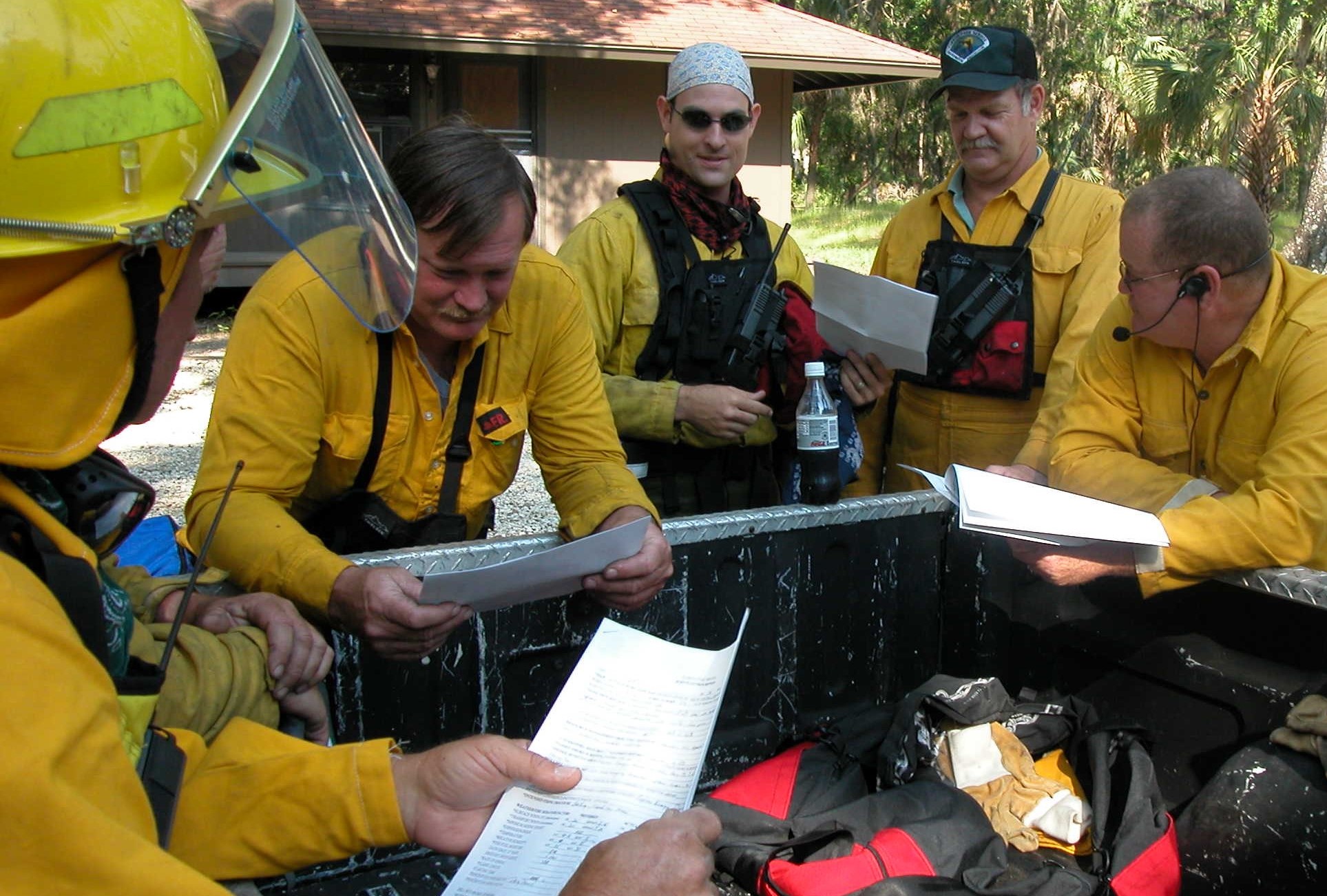 The fire team preparing for a prescribed burn by reviewing paperwork.