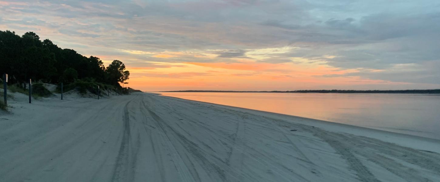 The sun rises over the beach at Amelia Island State Park.