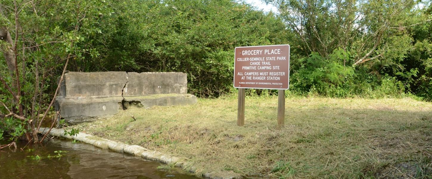 water grass and brown sign