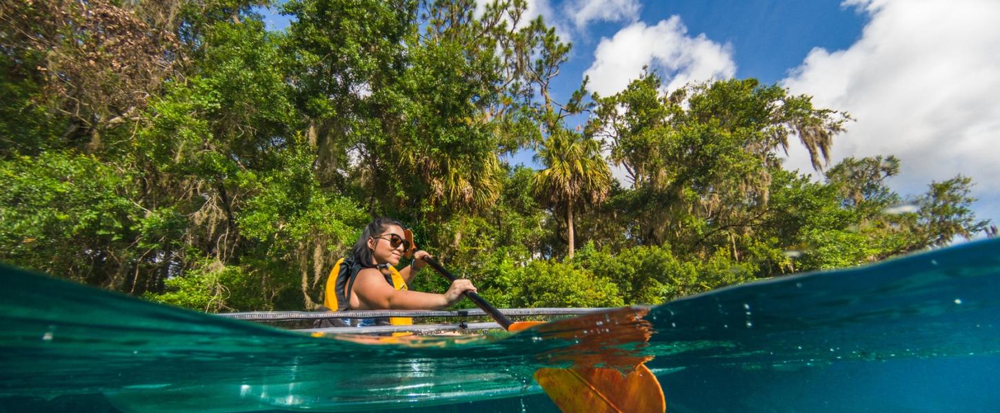 Paddler dips paddle into water at Rainbow Springs State Park 