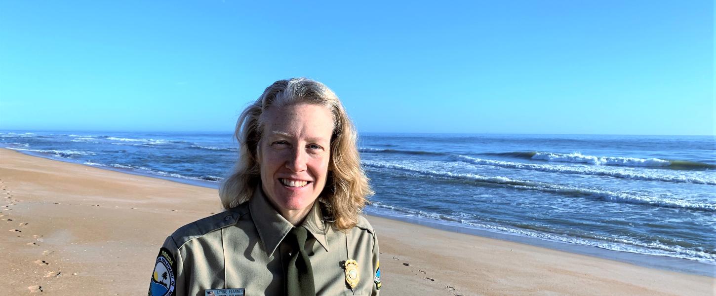 Lynne Flannery standing on the beach at Gamble Rogers Memorial State Recreation Area at Flagler Beach.