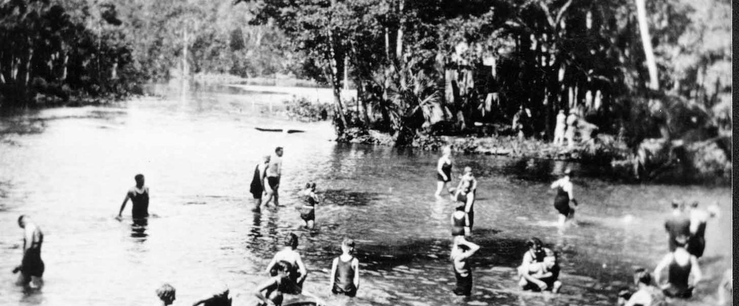 A black and white photo of people enjoying the springs.