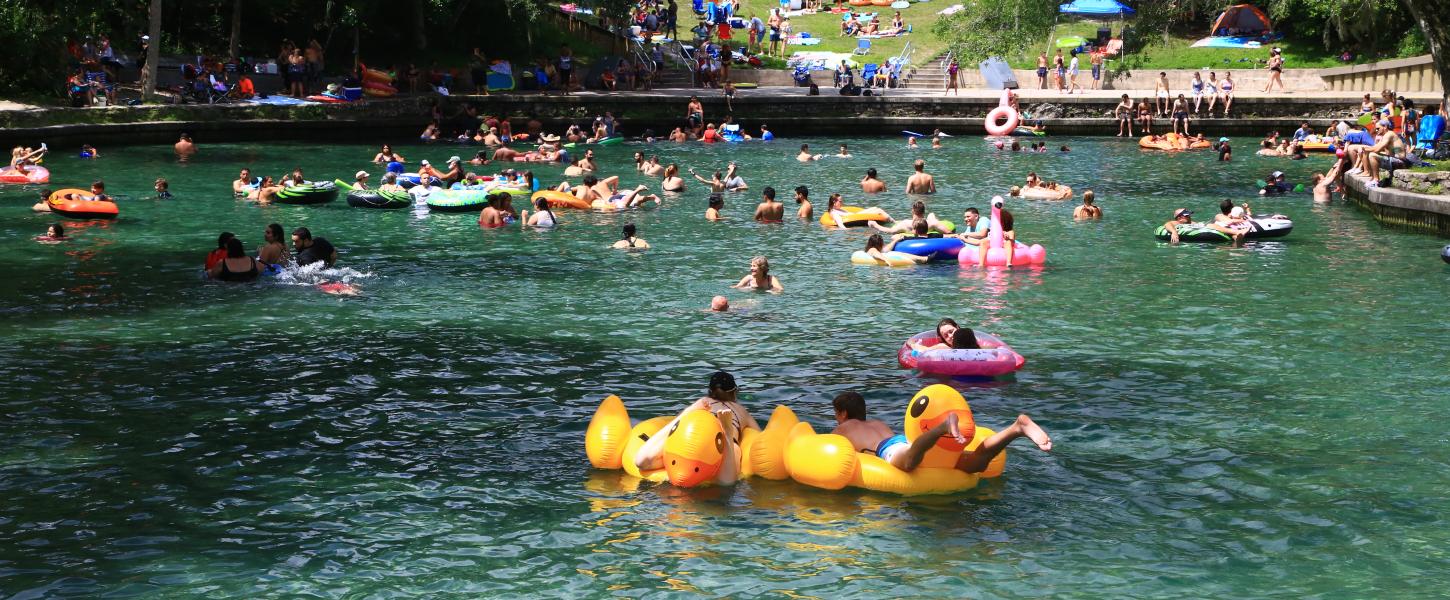 Visitors swimming at Wekiwa Springs with floaties 