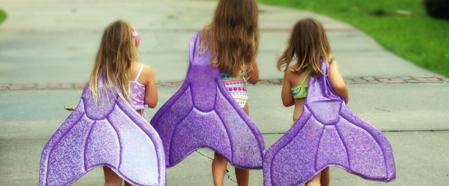 Little Girls Holding Mermaid Tails