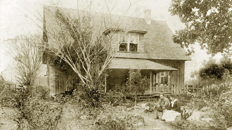The Dudley farmhouse with Norman and Winnie sitting in front from 1915