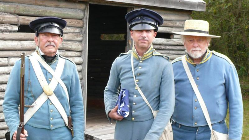A group of reenactors dressed in uniform.