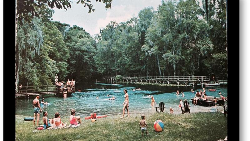 A 1960s image of Gilchrist Blue with people swimming and on shore. 