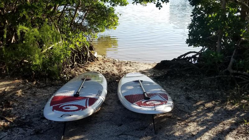 Two paddle boards at launch area by the water