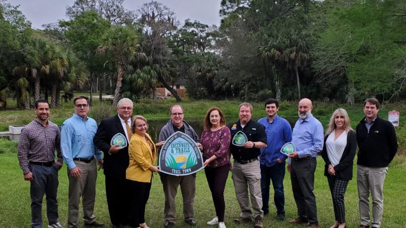 People posing with the City of DeBary 