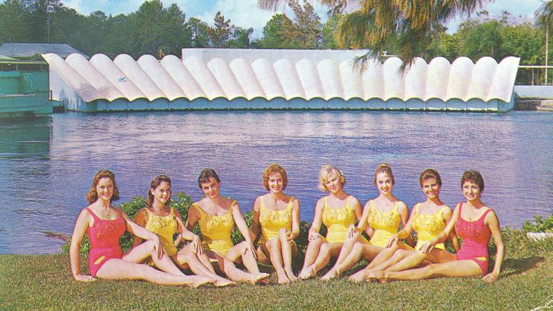 The first group of mermaids lined up in the grass in front of the theater at Weeki Wachee.