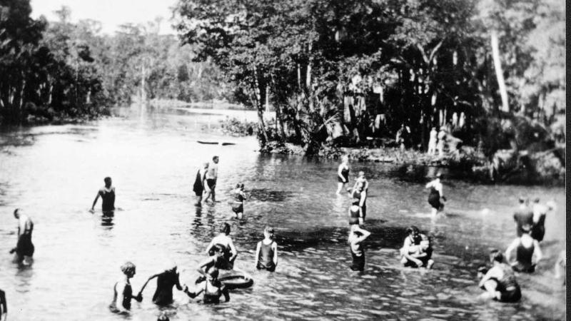 A black and white photo of people enjoying the springs.