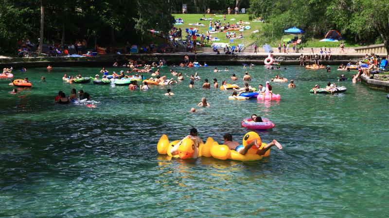 Visitors swimming at Wekiwa Springs with floaties 