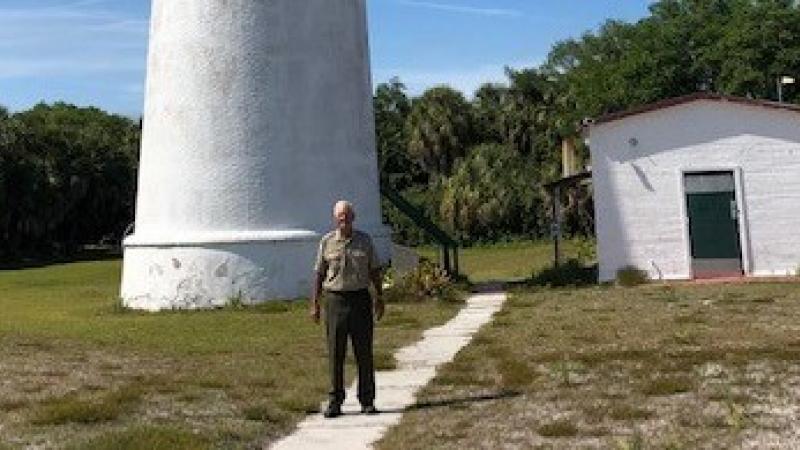 Tom Watson standing in front of the lighthouse at Egmont Key.