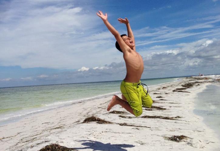 Kid Jumping on Beach