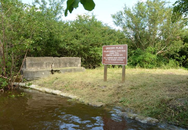 water grass and brown sign