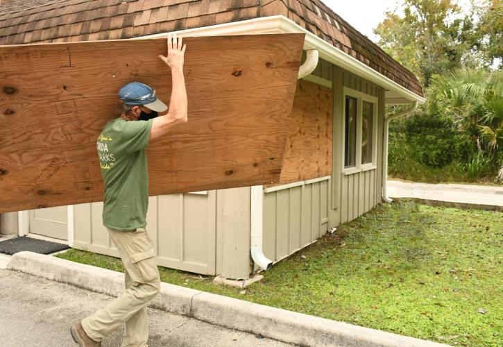 man carrying plywood