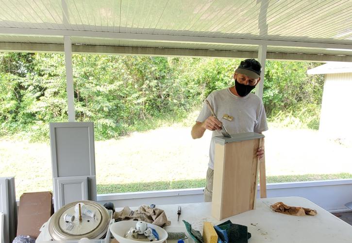 Man painting cabinets