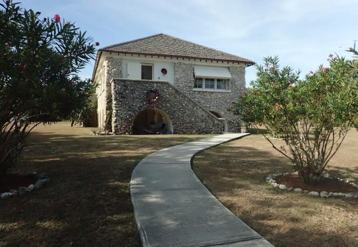 The two story stone home sits on Lignumvitae Key