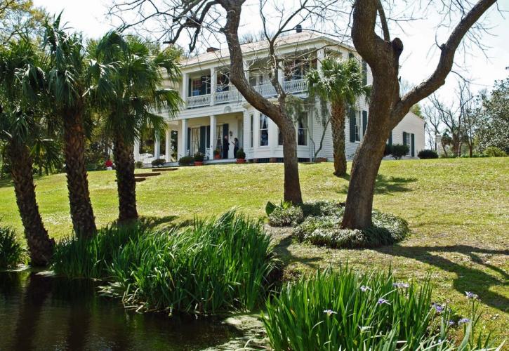 A view of the Orman House through the trees.