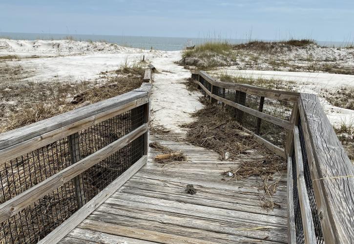 The West End boardwalk was damaged and the receding waters left behind debris and sand. 